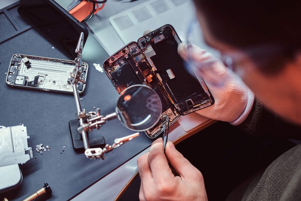 Technician repairing an iPhone at EZ Fix Cellphone Repair in Escondido